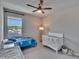 Bright bedroom with carpet, ceiling fan and window view, perfect for a comfortable and relaxing space at 7203 1/2 S West Shore Blvd, Tampa, FL 33616