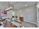 Well-lit dining room with modern light fixture and adjacent living area, offering a comfortable setting at 7203 1/2 S West Shore Blvd, Tampa, FL 33616