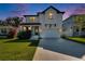 Charming two-story home featuring a well-manicured lawn and a two-car garage at 7203 1/2 S West Shore Blvd, Tampa, FL 33616