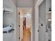 Hallway view of a bathroom featuring wood-look tile flooring, a shower with a curtain, and a window at 7203 1/2 S West Shore Blvd, Tampa, FL 33616
