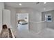 Open hallway provides views into a naturally lit bedroom with vaulted ceilings and carpet at 7203 1/2 S West Shore Blvd, Tampa, FL 33616