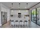 Bright, modern kitchen featuring white cabinets, center island with seating, and stainless appliances at 7203 1/2 S West Shore Blvd, Tampa, FL 33616