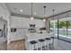 Modern kitchen with white cabinets, a center island with seating, and stainless steel appliances at 7203 1/2 S West Shore Blvd, Tampa, FL 33616