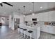 Bright kitchen with white cabinets, quartz countertops, stainless steel appliances, and a large kitchen island with seating at 7203 1/2 S West Shore Blvd, Tampa, FL 33616