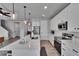 Modern kitchen with white cabinets, quartz countertops, stainless steel appliances, and a large kitchen island at 7203 1/2 S West Shore Blvd, Tampa, FL 33616
