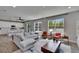 Spacious living room with large windows, recessed lighting, ceiling fan, and view into the kitchen at 7203 1/2 S West Shore Blvd, Tampa, FL 33616