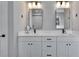 Bright bathroom with double vanity, square mirrors, and sleek black faucets at 7203 1/2 S West Shore Blvd, Tampa, FL 33616