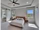 Naturally lit main bedroom features tray ceilings, carpet, and views to exterior at 7203 1/2 S West Shore Blvd, Tampa, FL 33616