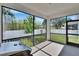 Screened porch featuring a grill, perfect for outdoor cooking and entertaining with views of the fenced-in yard at 7203 1/2 S West Shore Blvd, Tampa, FL 33616