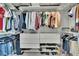 Organized walk-in closet featuring shelving, hanging rods, drawers, and shoe storage to maximize storage space at 7203 1/2 S West Shore Blvd, Tampa, FL 33616