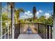 Balcony view of the outside with a car parked in the driveway at 803 Harbor Dr, Belleair Beach, FL 33786