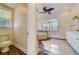Bright bathroom with a soaking tub under a window and decorative floor at 803 Harbor Dr, Belleair Beach, FL 33786