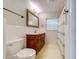 Bathroom with a carved wooden vanity, commode, and shower/tub combination at 803 Harbor Dr, Belleair Beach, FL 33786