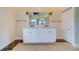 Bathroom vanity with double sinks, a large mirror and decorative lighting at 803 Harbor Dr, Belleair Beach, FL 33786