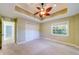 Bedroom featuring neutral carpeting and paint, a ceiling fan, and a double closet at 803 Harbor Dr, Belleair Beach, FL 33786