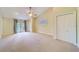 Bedroom with carpet, ceiling fan, and access to outdoor area with French doors at 803 Harbor Dr, Belleair Beach, FL 33786