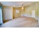 Bedroom with neutral walls, carpet, ceiling fan, and double door closet at 803 Harbor Dr, Belleair Beach, FL 33786