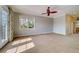 Bedroom with neutral paint, ceiling fan and a large window providing natural light at 803 Harbor Dr, Belleair Beach, FL 33786