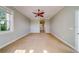 Bright bedroom with ceiling fan and a window overlooking the yard at 803 Harbor Dr, Belleair Beach, FL 33786