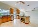 Open kitchen features wood cabinets, granite countertops, an island, and stainless steel appliances at 803 Harbor Dr, Belleair Beach, FL 33786
