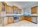 Well-equipped kitchen with stainless steel appliances, granite countertops, and wood cabinets at 803 Harbor Dr, Belleair Beach, FL 33786