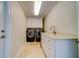Clean and functional laundry room with modern appliances and storage at 803 Harbor Dr, Belleair Beach, FL 33786