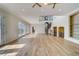 Spacious living room with hardwood floors and spiral staircase leading to the second floor at 803 Harbor Dr, Belleair Beach, FL 33786