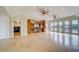 Open living space with tile flooring, French doors and an adjacent kitchen and laundry room at 803 Harbor Dr, Belleair Beach, FL 33786