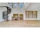 Spacious living room with a spiral staircase and hardwood floors at 803 Harbor Dr, Belleair Beach, FL 33786