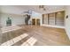 Spacious living room with hardwood floors, built-in bookshelves, and a spiral staircase at 803 Harbor Dr, Belleair Beach, FL 33786