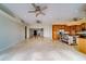Open-concept living room with travertine floors, high ceilings, and recessed lighting at 803 Harbor Dr, Belleair Beach, FL 33786