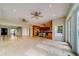 Expansive living area with tile floors leading to a kitchen and staircase at 803 Harbor Dr, Belleair Beach, FL 33786