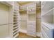 Walk-in closet with custom shelving, drawers and ample storage space for clothing at 803 Harbor Dr, Belleair Beach, FL 33786