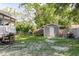 A fenced backyard features a storage shed, small trees, picnic table, and a grill, making it ideal for outdoor entertaining at 8517 N Branch Ave, Tampa, FL 33604