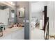 This primary bathroom features a vanity with a mirror and an open door to the bedroom at 8517 N Branch Ave, Tampa, FL 33604