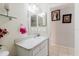 Bathroom with a single sink vanity and mirror, toilet, and neutral wall paint at 8517 N Branch Ave, Tampa, FL 33604