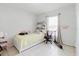 Light bedroom with white tile, window, and desk at 8517 N Branch Ave, Tampa, FL 33604