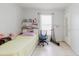 Comfortable bedroom with tile flooring, storage, and natural light at 8517 N Branch Ave, Tampa, FL 33604