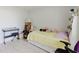Cozy bedroom with tile floors and a keyboard with a bench at 8517 N Branch Ave, Tampa, FL 33604