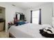 Bedroom featuring a window with natural light, TV on dresser and tile flooring at 8517 N Branch Ave, Tampa, FL 33604