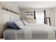 Bedroom features a bed with a white headboard, a dresser with a mirror, and neutral colored walls at 8517 N Branch Ave, Tampa, FL 33604