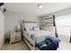 Bedroom features a bed with a white headboard, a dresser with a mirror, and neutral colored walls at 8517 N Branch Ave, Tampa, FL 33604