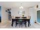 A formal dining area features a large dining table, a chandelier, and a view into the kitchen area at 8517 N Branch Ave, Tampa, FL 33604