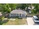 Charming single-story home with a well-maintained lawn, neutral colors, and a cozy front porch and a basketball hoop at 8517 N Branch Ave, Tampa, FL 33604