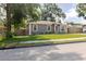 This well-maintained gray single-story home features white trim and a lush green lawn, perfect for a Gathering at 8517 N Branch Ave, Tampa, FL 33604
