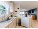 Bright kitchen with white cabinets and countertops, and an eat-in counter at 8517 N Branch Ave, Tampa, FL 33604