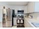 Bright kitchen features stainless steel appliances, white cabinetry, and modern tile backsplash at 8517 N Branch Ave, Tampa, FL 33604