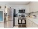 Bright kitchen features stainless steel appliances, white cabinetry, and modern tile backsplash at 8517 N Branch Ave, Tampa, FL 33604