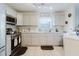 A well-lit kitchen featuring modern appliances, light gray cabinets, and tiled flooring at 8517 N Branch Ave, Tampa, FL 33604