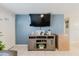A cozy living room featuring a large television, neutral paint, and tiled flooring at 8517 N Branch Ave, Tampa, FL 33604